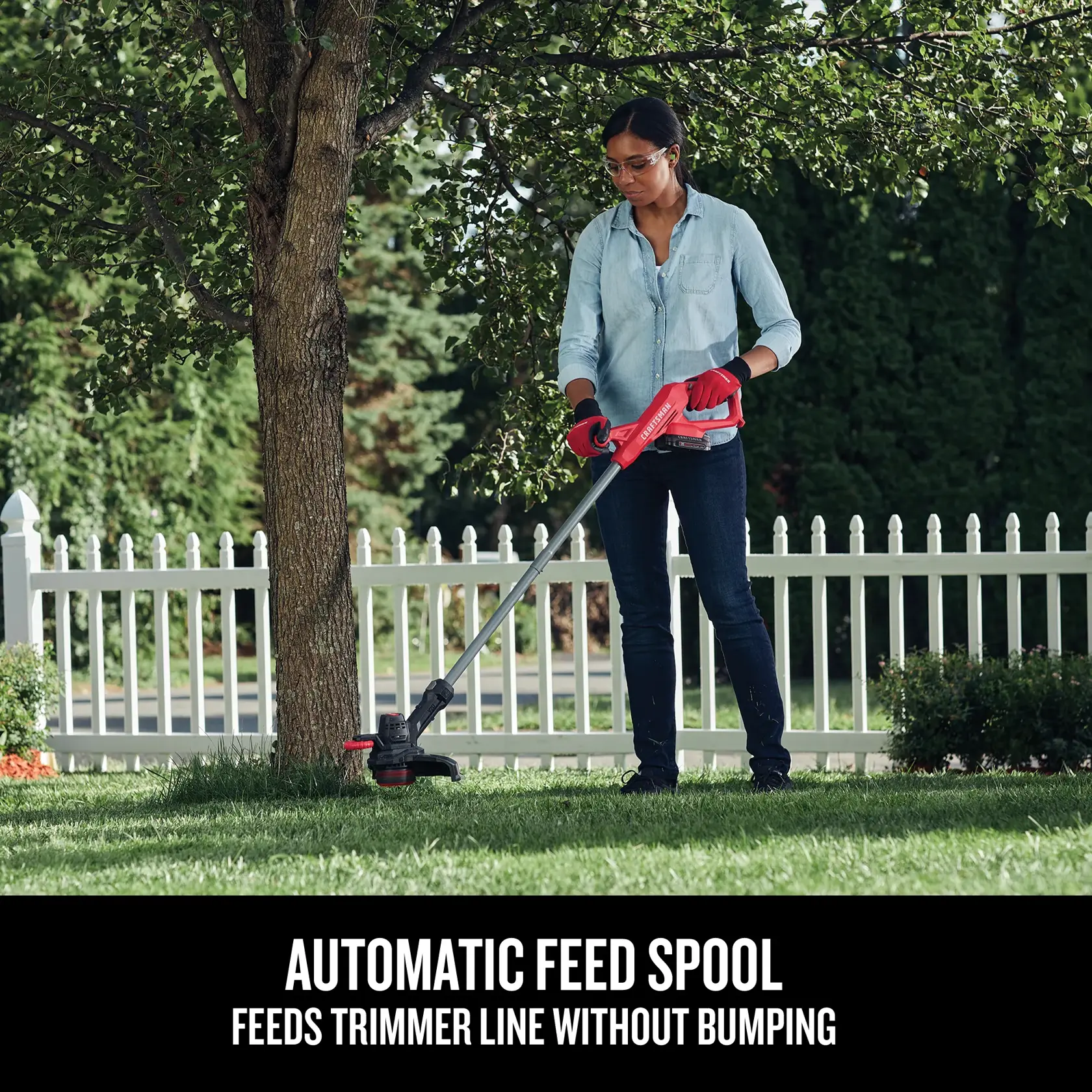 Woman using the string trimmer around a tree, with text highlighting the automatic feed spool