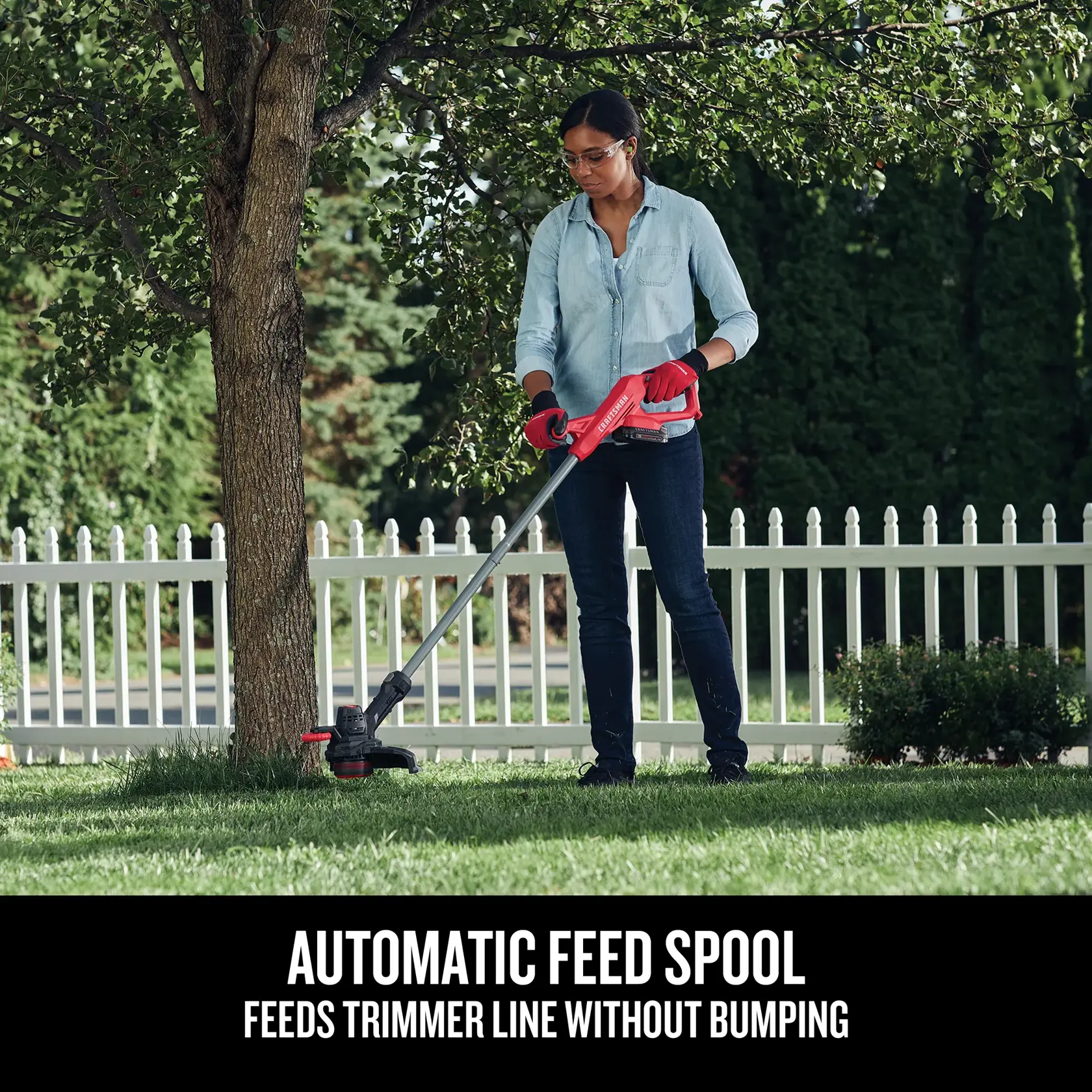 Craftsman CMCST915C1 string trimmer used outdoors near tree, showing automatic feed spool feature.