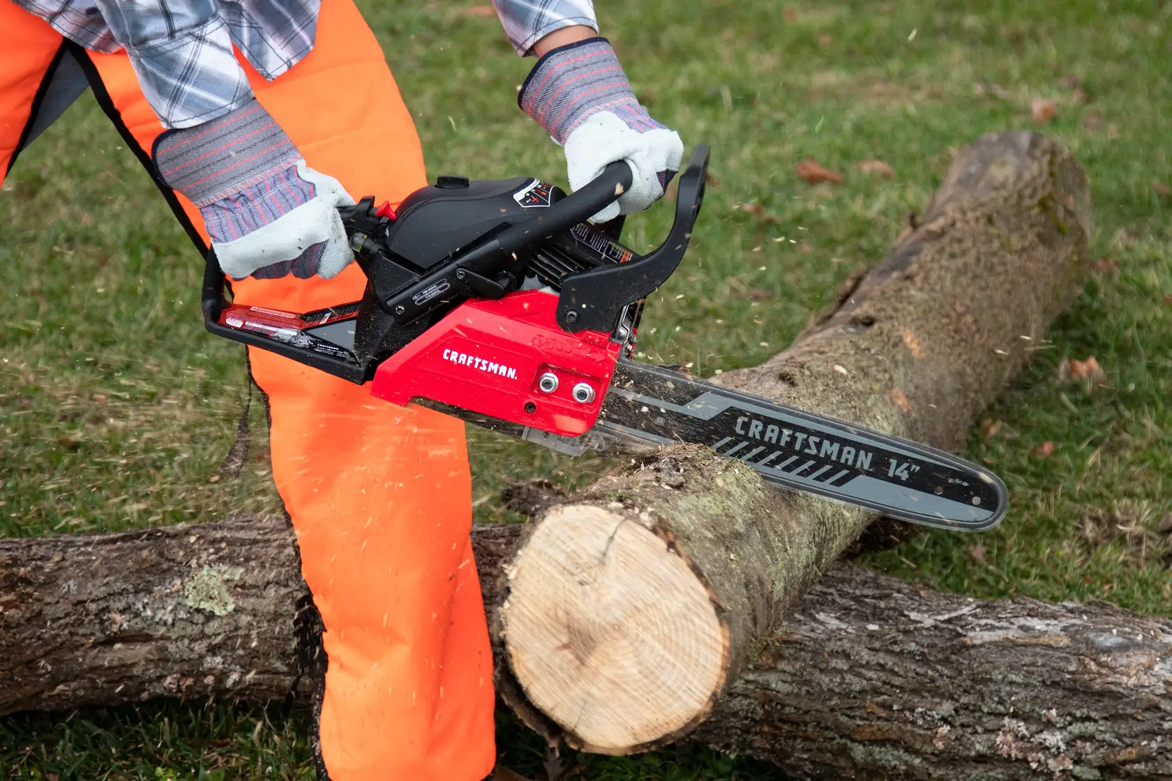  CRAFTSMAN S210 14 in. Gas Chainsaw being used to cut a log
