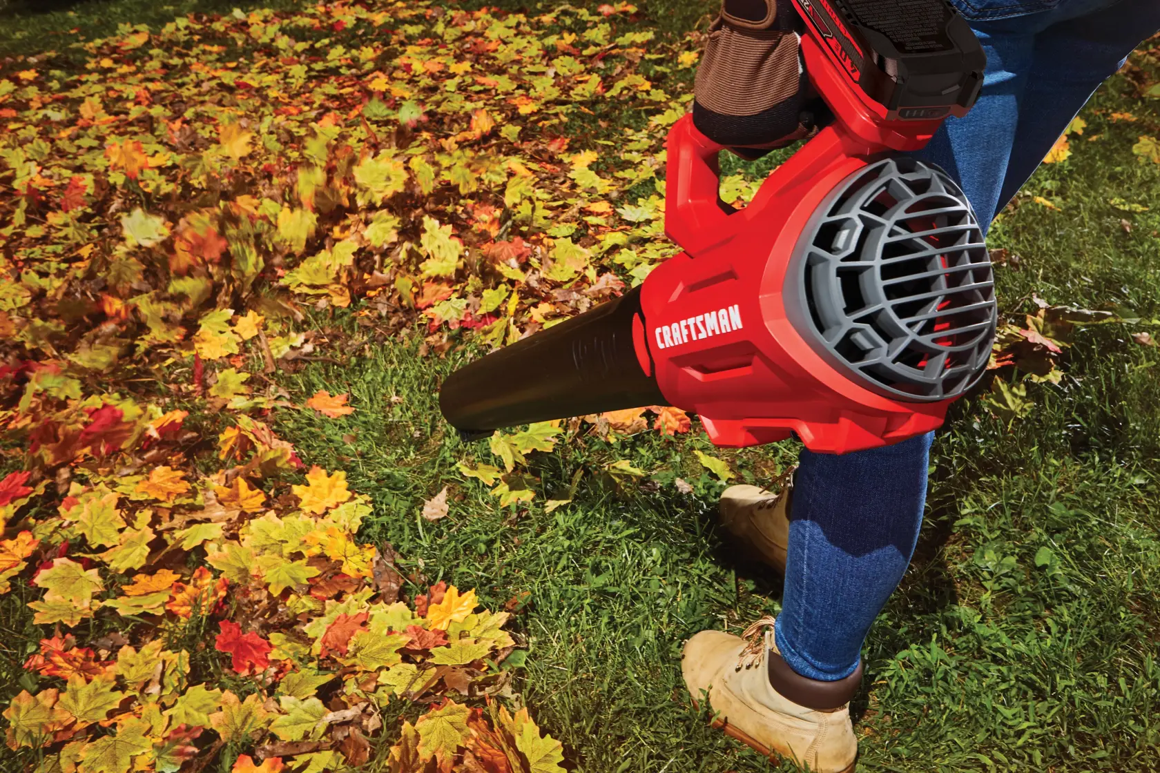 Person using CRAFTSMAN V20* Cordless Axial Leaf Blower Kit in yard
