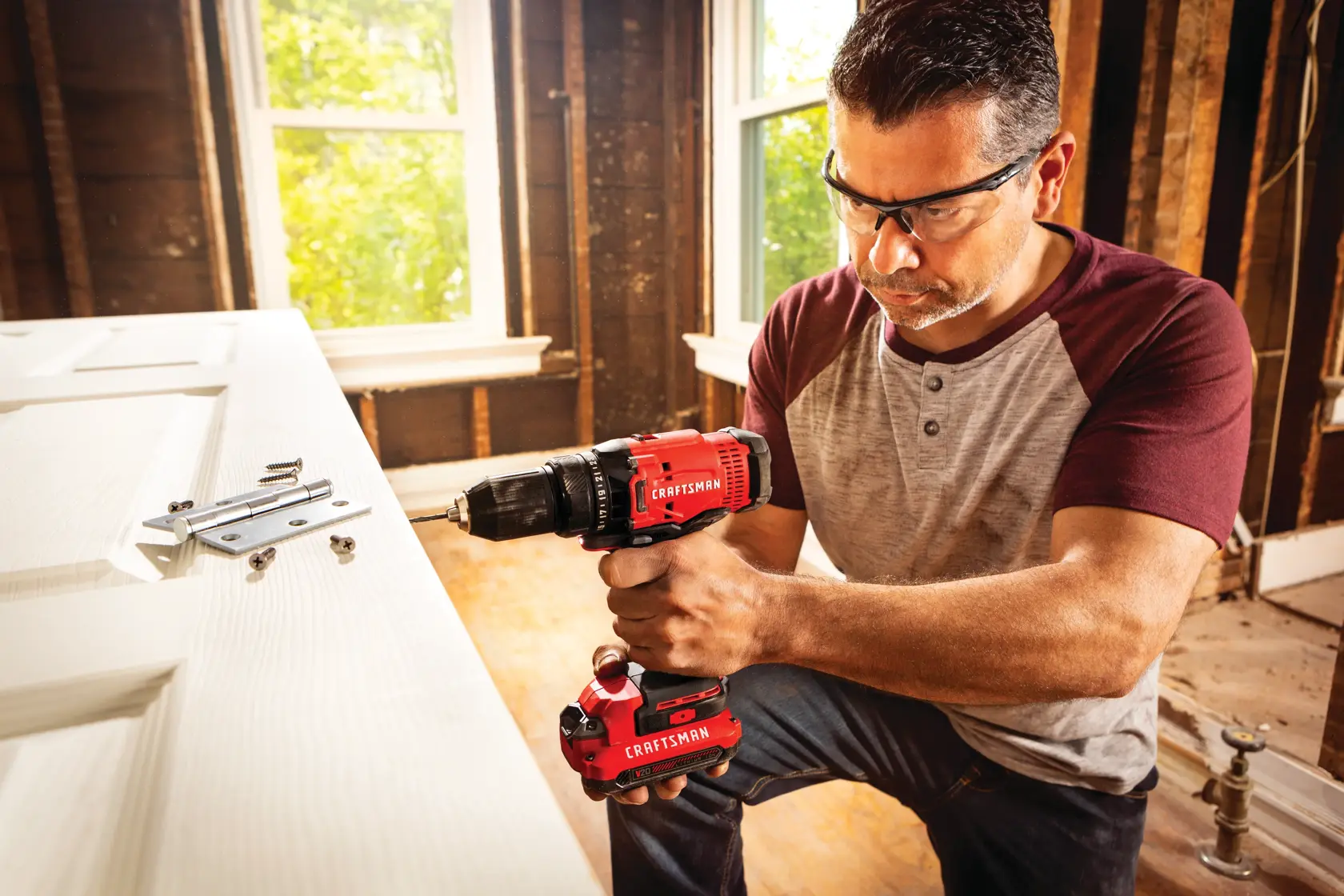 Cordless half inch drill and driver kit 1 battery being used for drilling in wooden door.