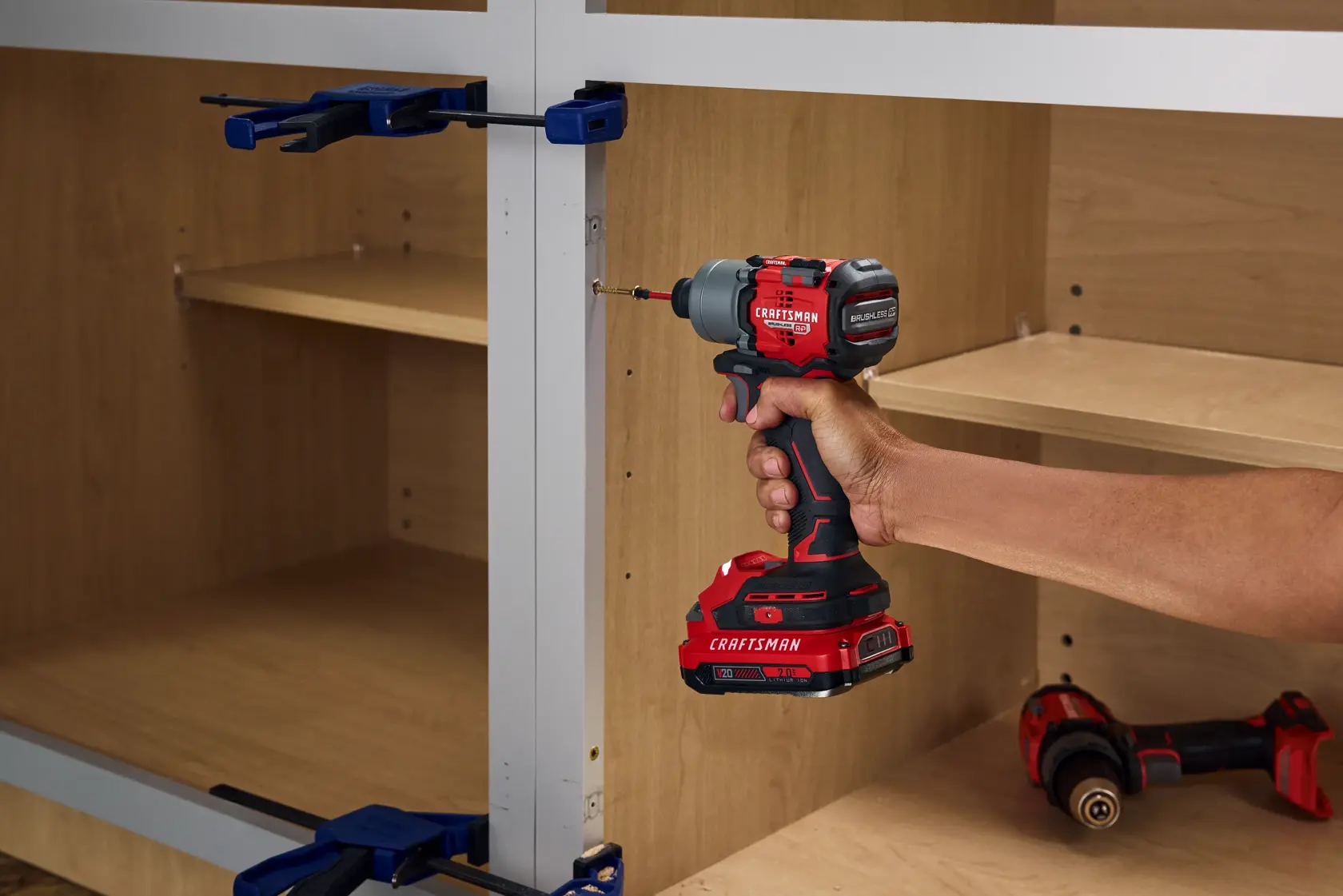 Photo of Craftsman cordless impact driver CMCF830B in use on wooden shelving, handheld.