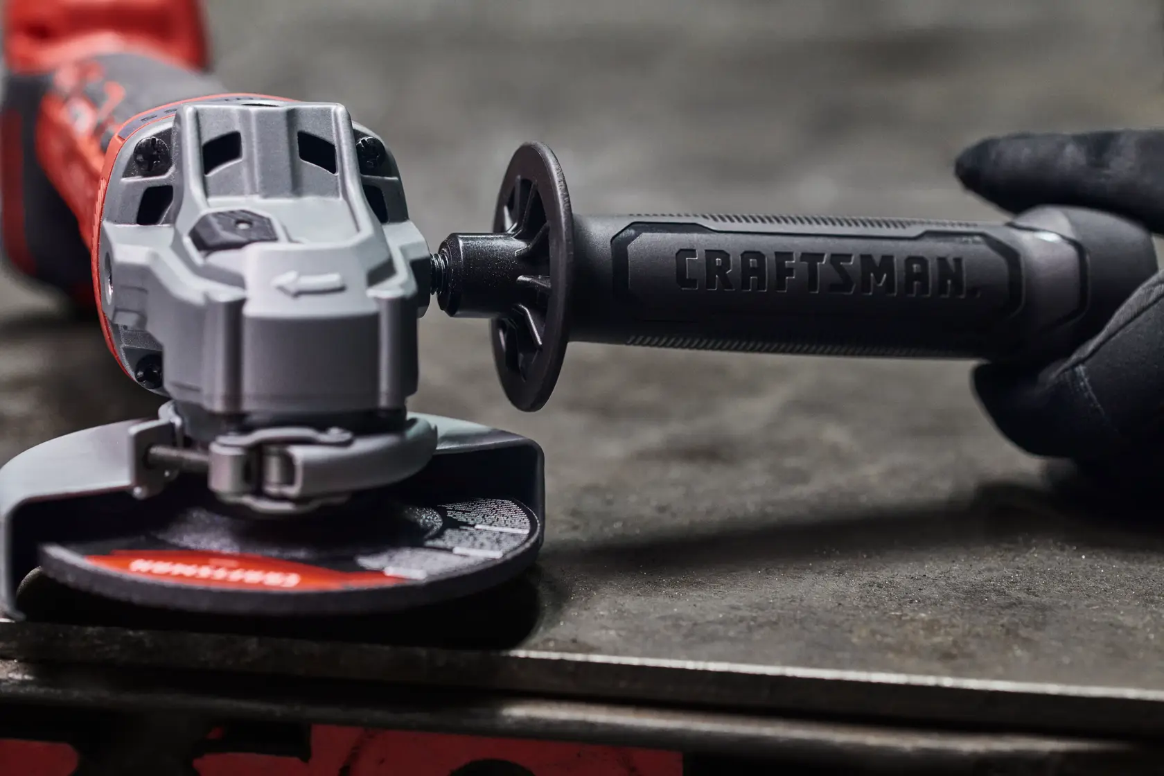 Photo of Craftsman angle grinder CMCG451B with textured handle, close-up view on workbench.