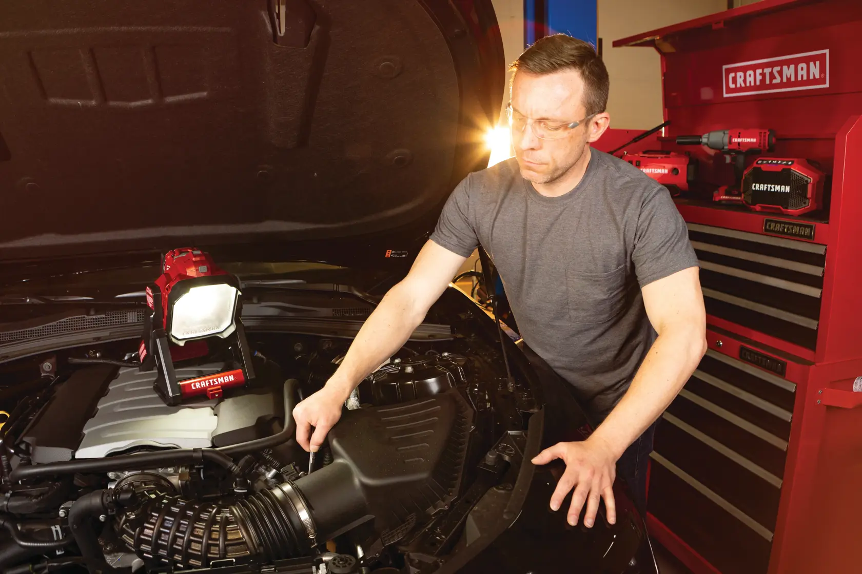 Cordless small area light tool only being used for fixing car engine.