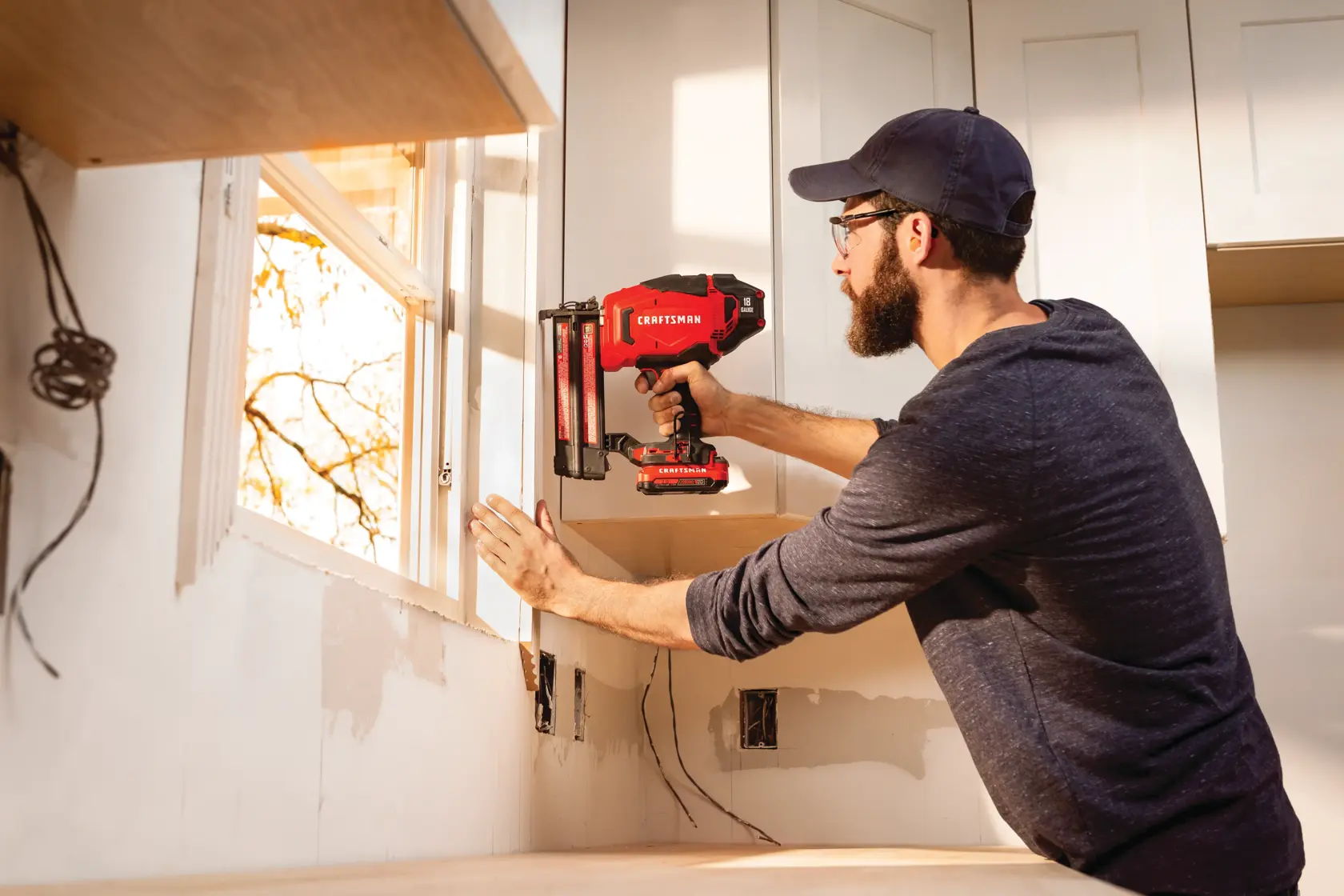 Cordless 16 gauge finish nailer kit 1 battery being used on window frame.