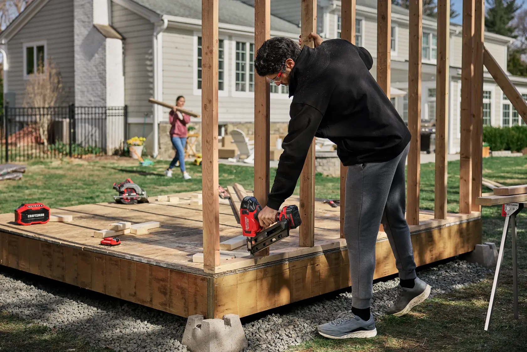 Man building deck with CRAFTSMAN BRUSHLESS RP™ V20* 30° Paper Collated Framing Nailer