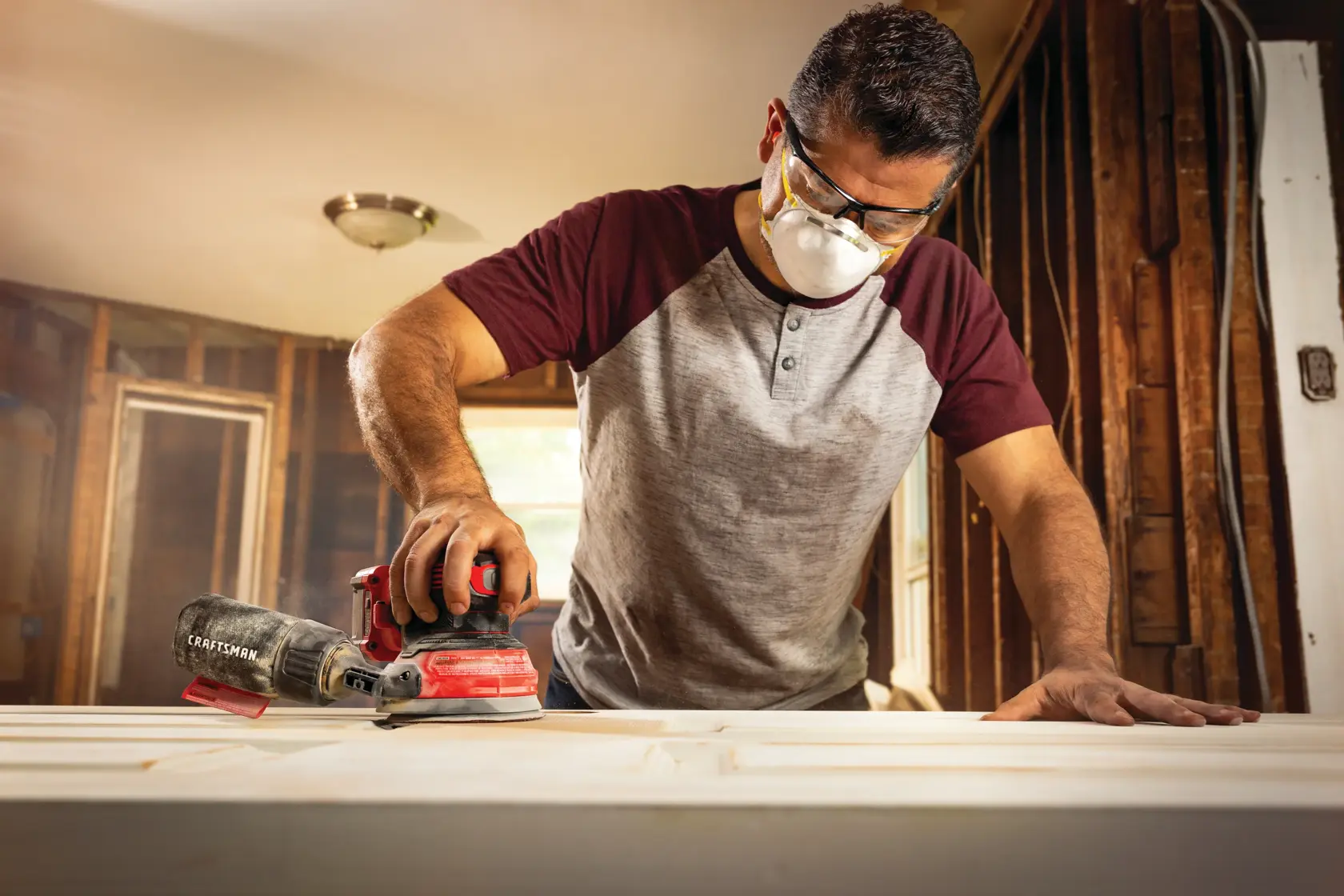 20 volt cordless random orbit sander being used by a person.