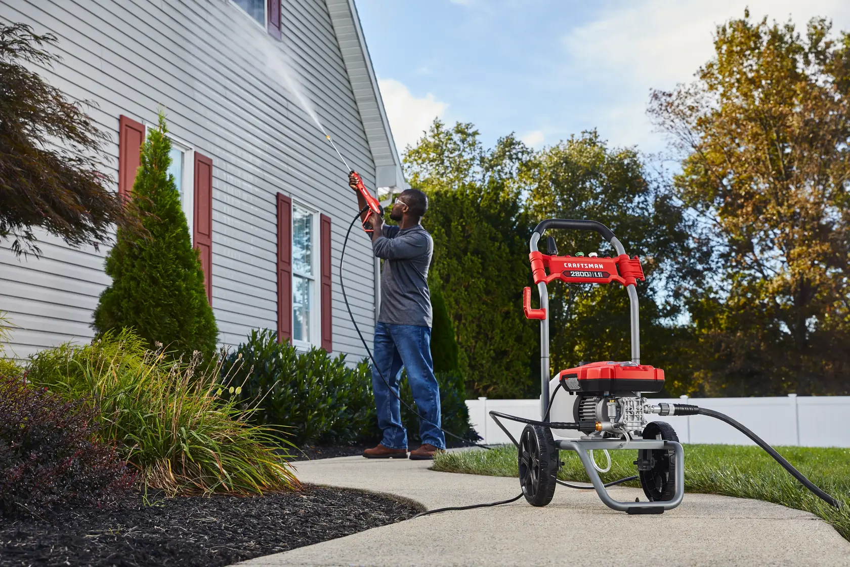 CRAFTSMAN 2800 Pressure Washer pressure washing second story of home with shrubs and fence