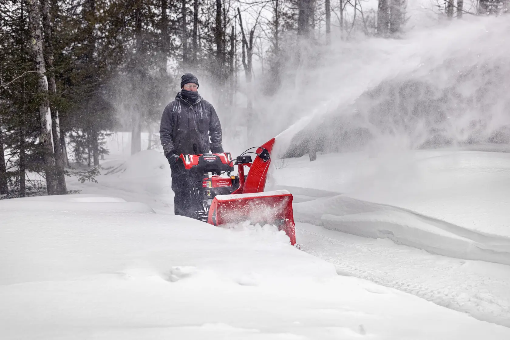 CRAFTSMAN Performance 28 Gas Snow Blower clearning driveway near wooded area
