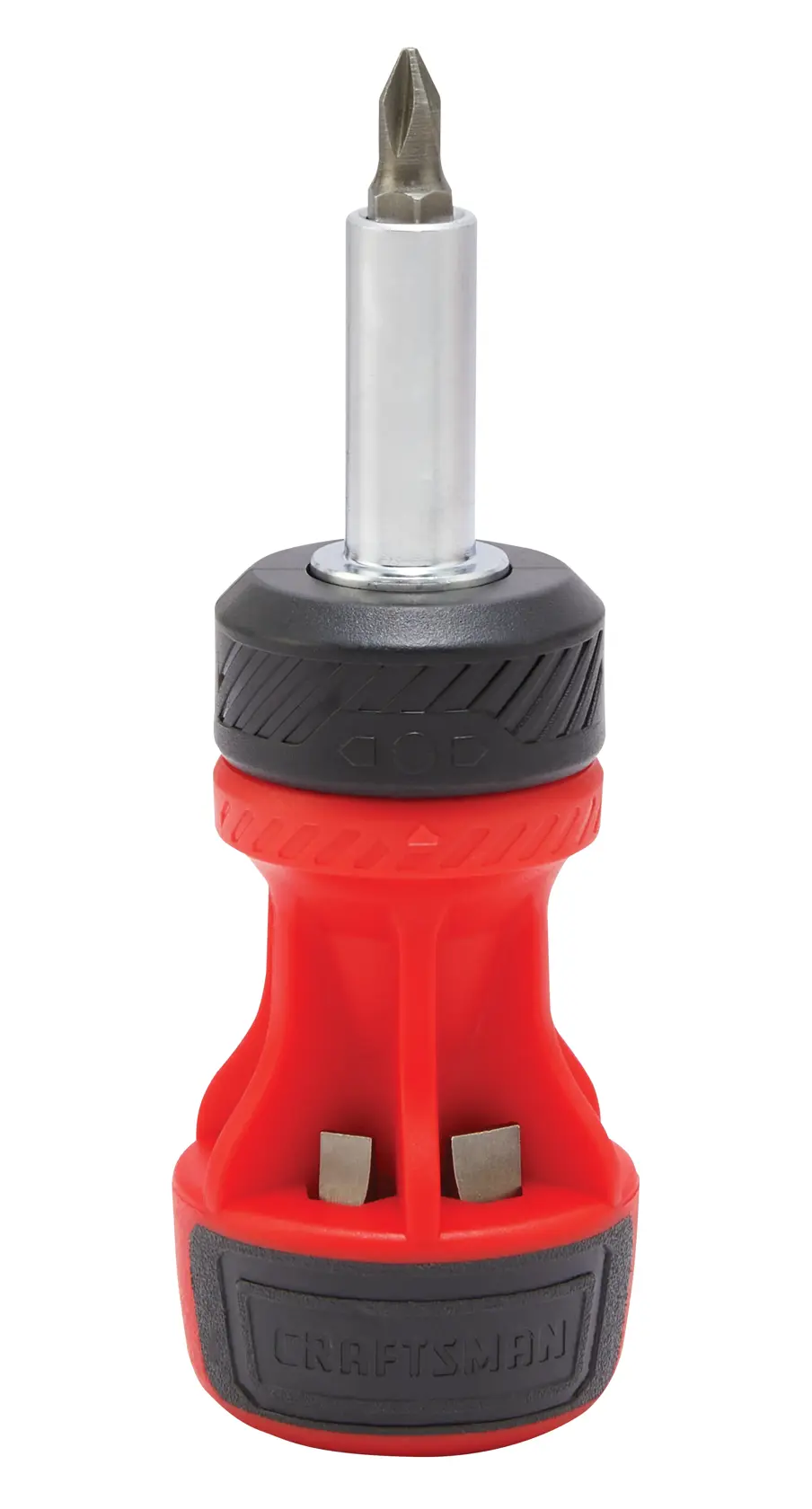 A stubby screwdriver with a red and black handle, featuring interchangeable bits stored in the handle. The bit currently attached is a Phillips head.